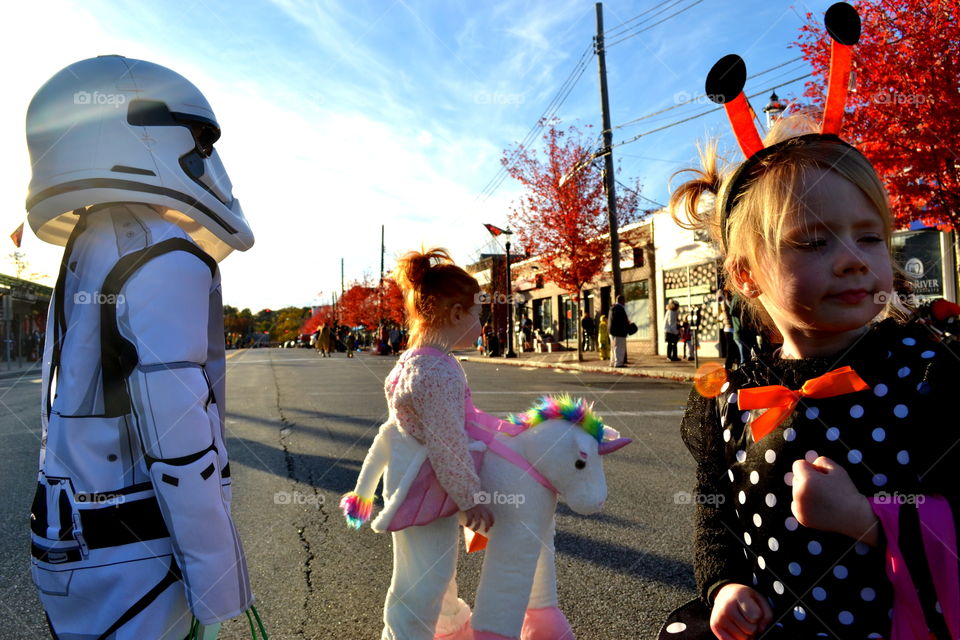 Little children's in costume walking on street