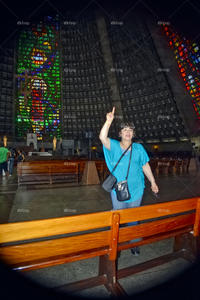 Woman pointing upward in church