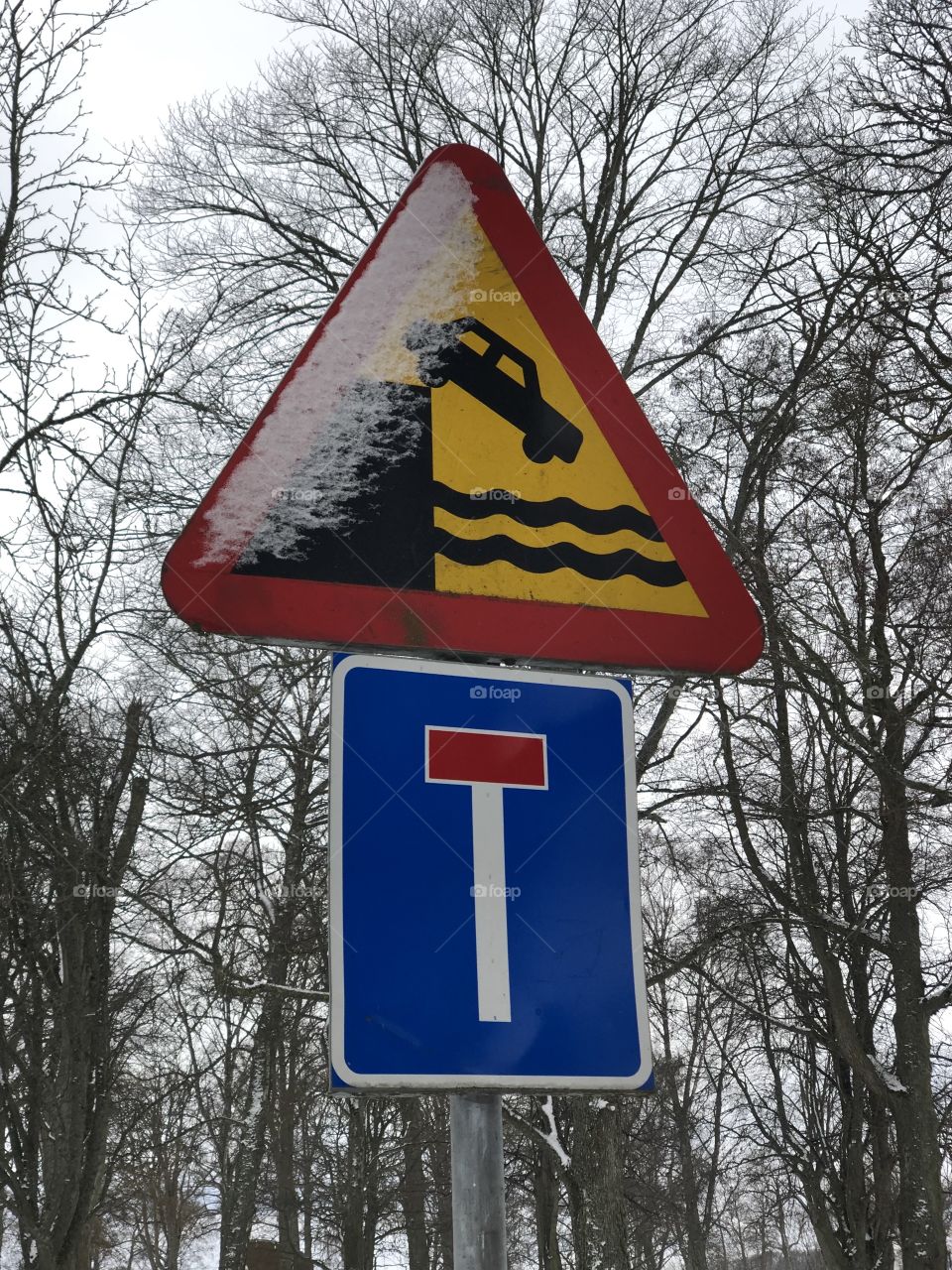 Car falling water danger road sign in sweden 