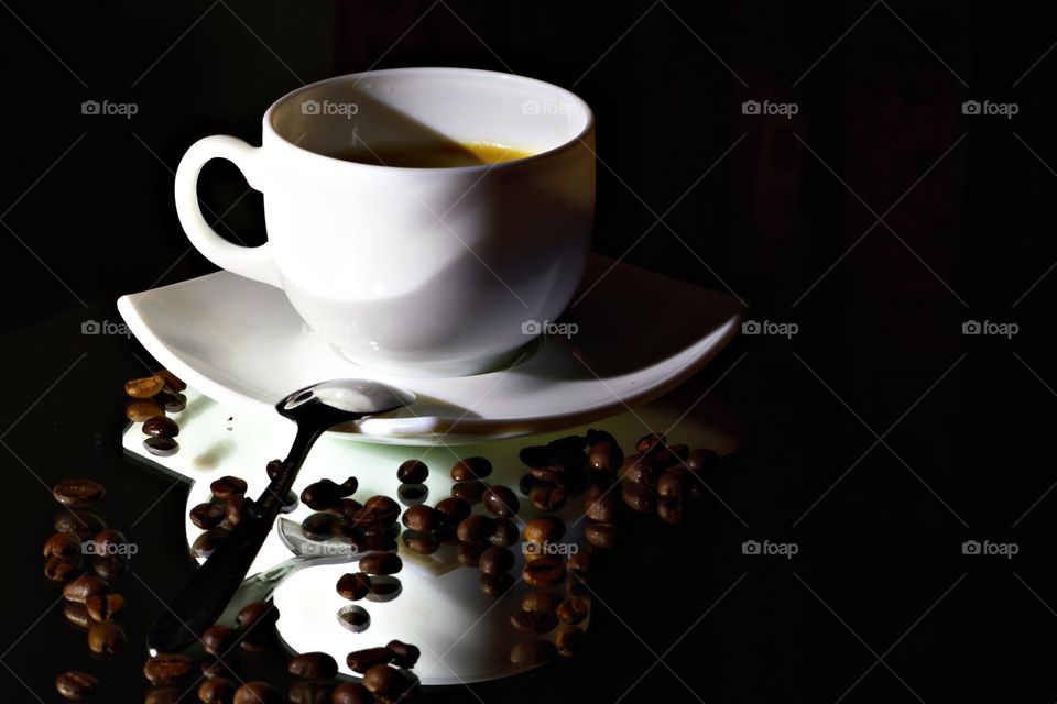 Coffee cup reflecting on table