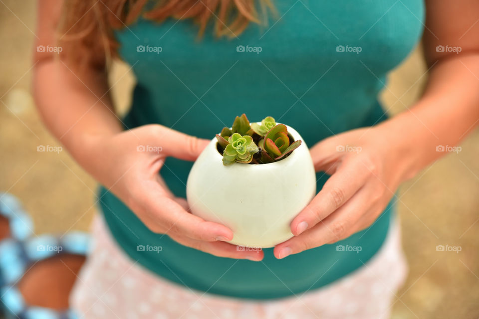 girl holding a cactus