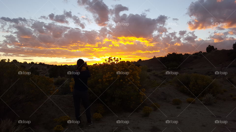 Beautiful girl capturing a beautiful sunset