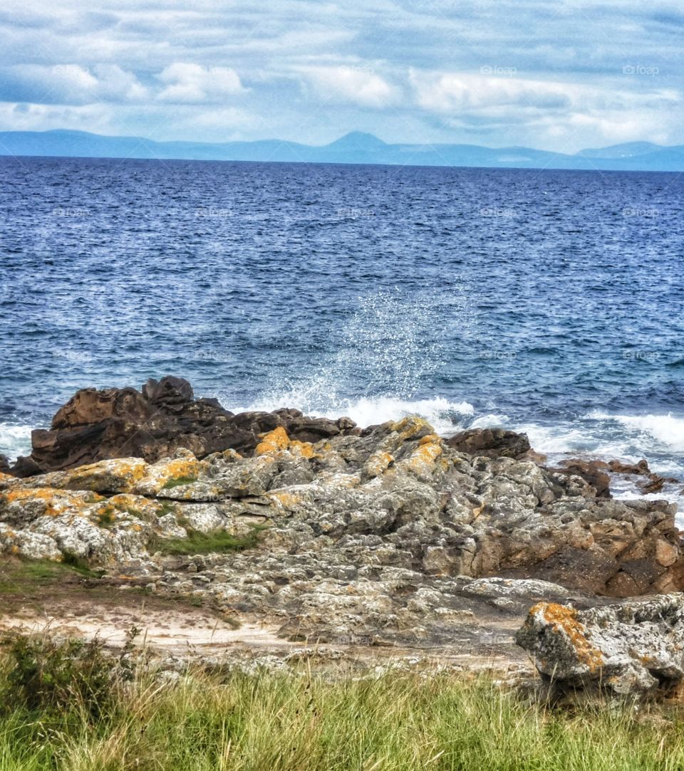 Scottish sea crashing against rocks