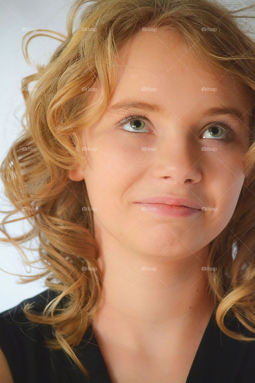 Happy smiling girl in curly hair