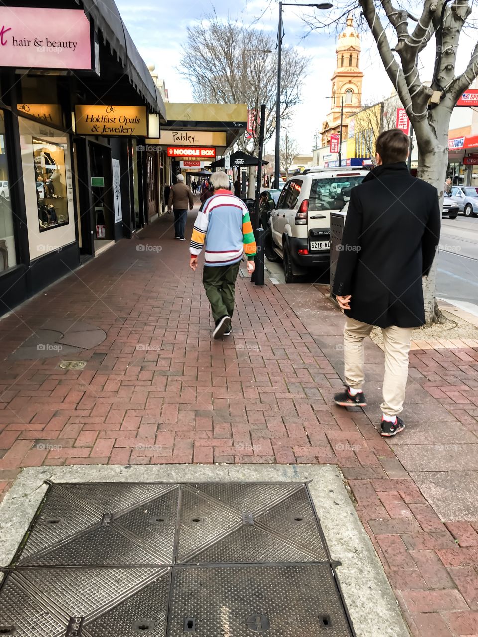 Adelaide street scene young man in black coat walking