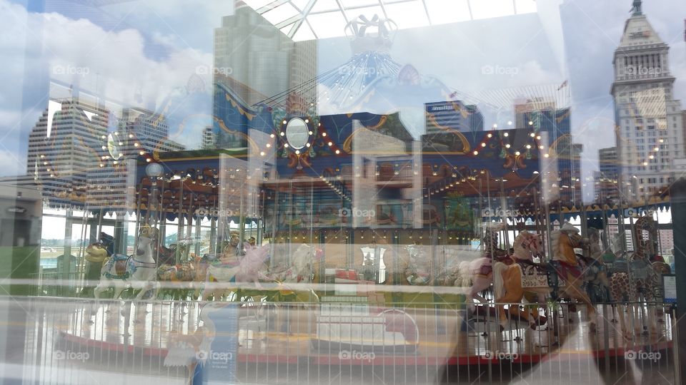 Reflections. Looking through the windows to the carousel, the city behind us was reflecting in the window. Cincinnati, Ohio.