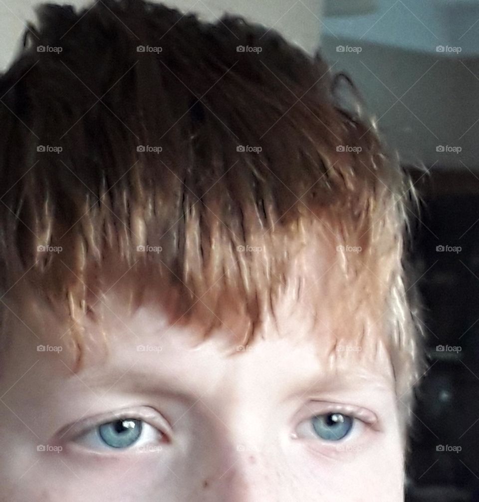 blue eyes of redhead boy