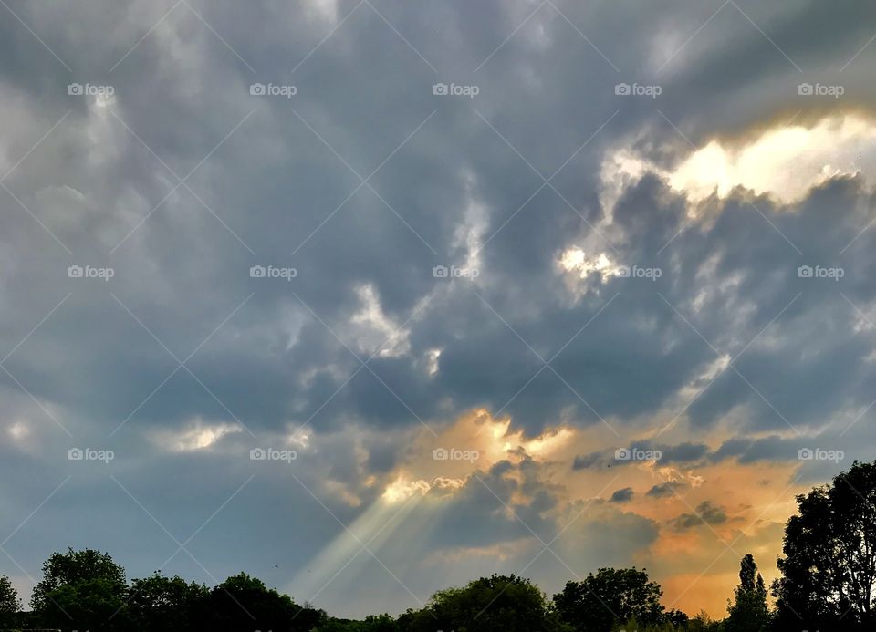 Sunlight bursting through the clouds as the sun sets 