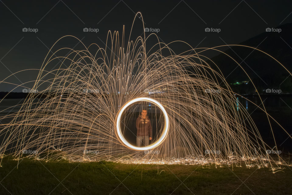 Man performing fire show at night