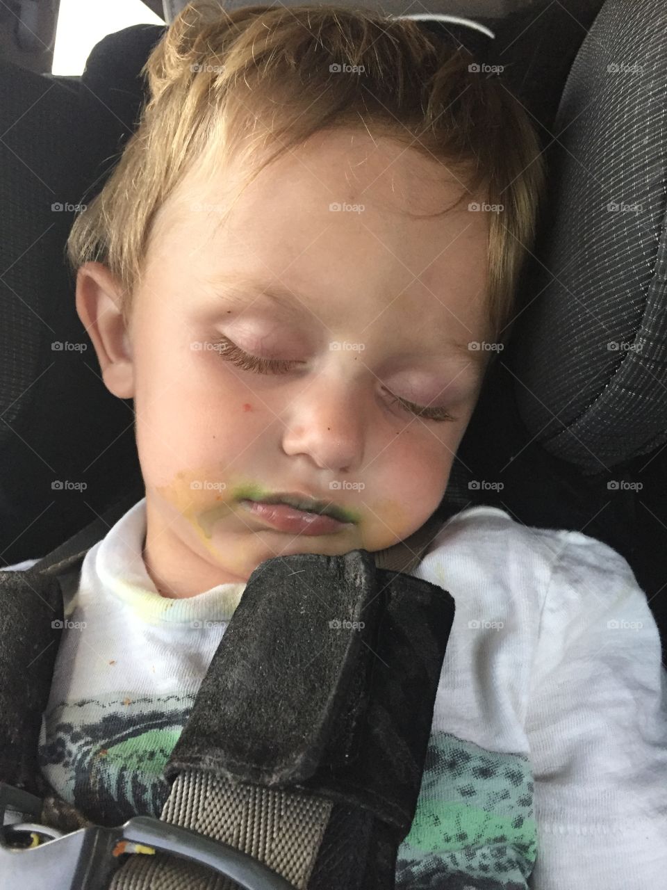 Boy sleeping in car