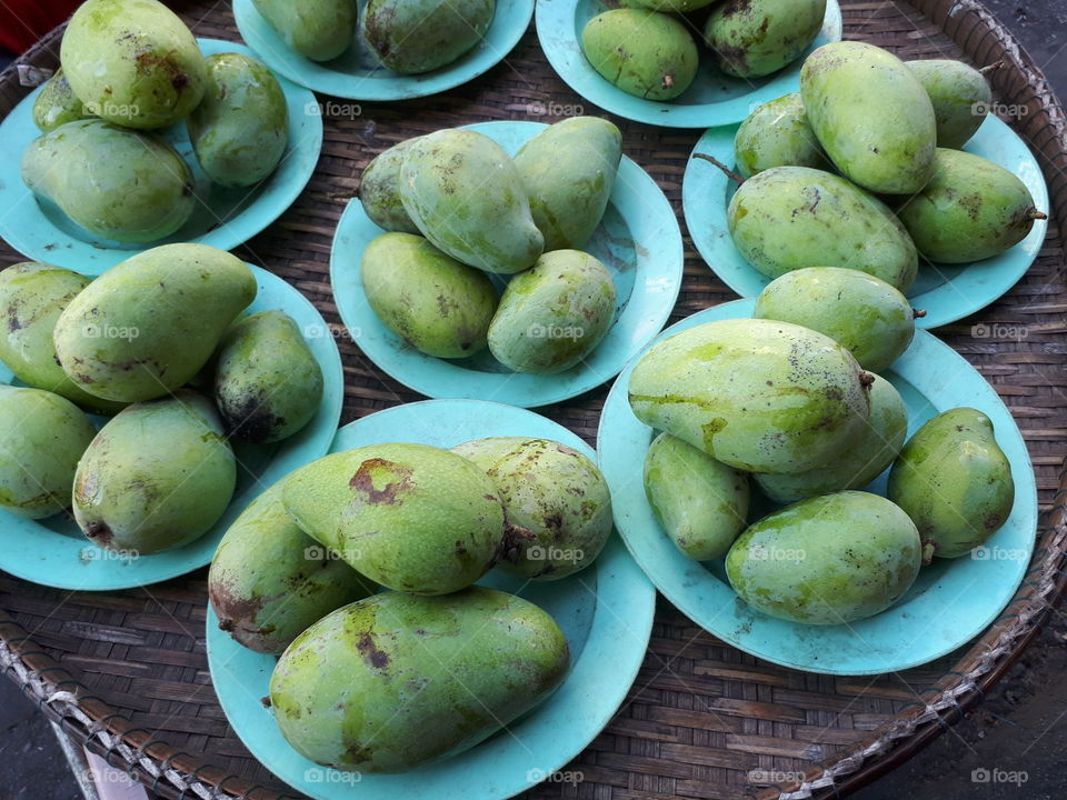 Stack of mangoes on plate