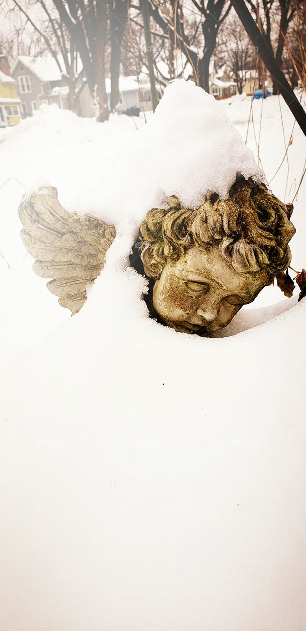 I took this picture of this beautiful  angel i have in my yard when we had a lot of snow i just think is is berth taking