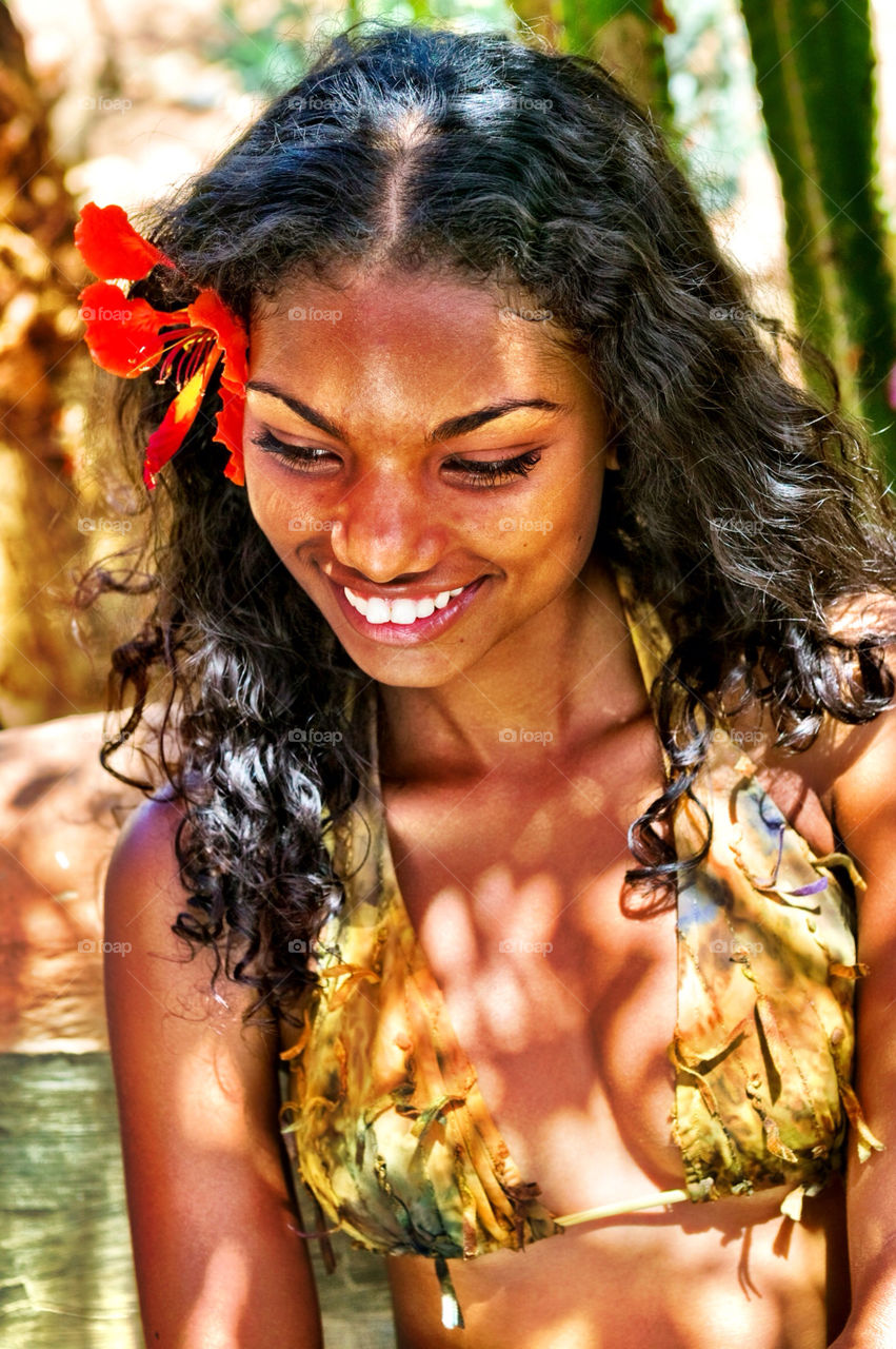 Black woman with flower on head