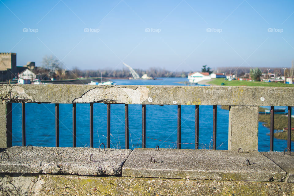 Stone bridge on the Danube River. Old stone bridge. View from it. Blue sky and water.