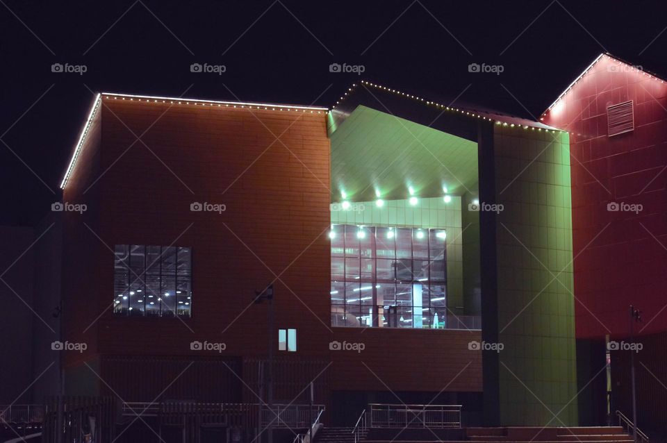 huge windows of a shopping center glowing in the night