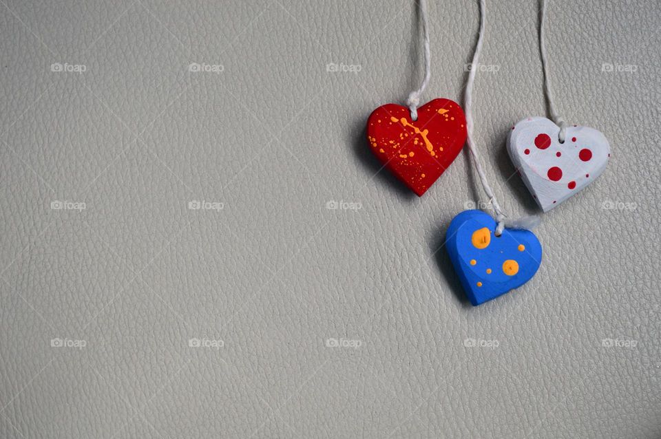 Multicolored wooden hearts on a thread
