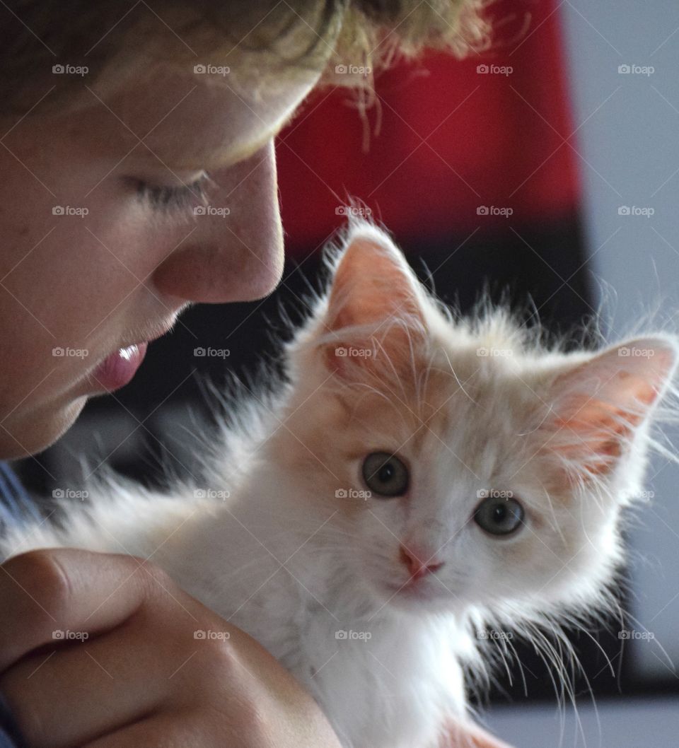 Teenage boy holding cute cat