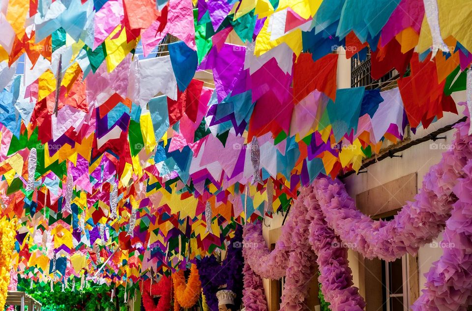 Street decorated with colourful tissue paper for Festas Dos Tabuleiros in Portugal