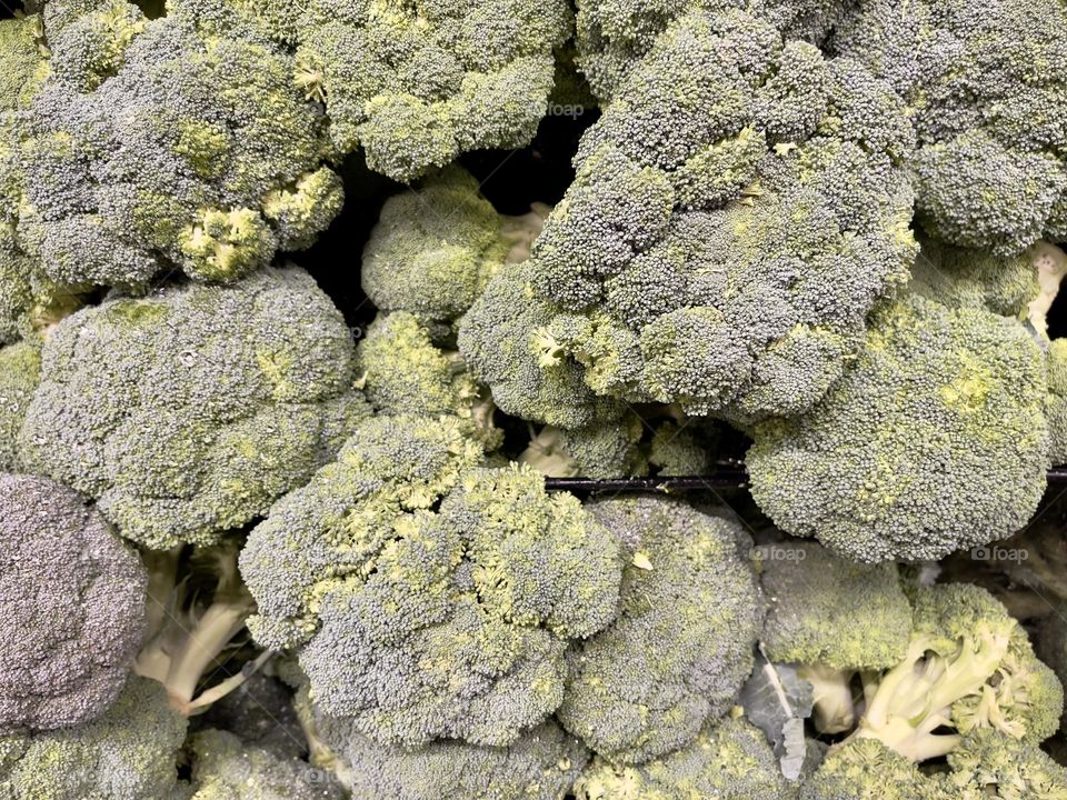 Green broccoli on the market shelf, top view 