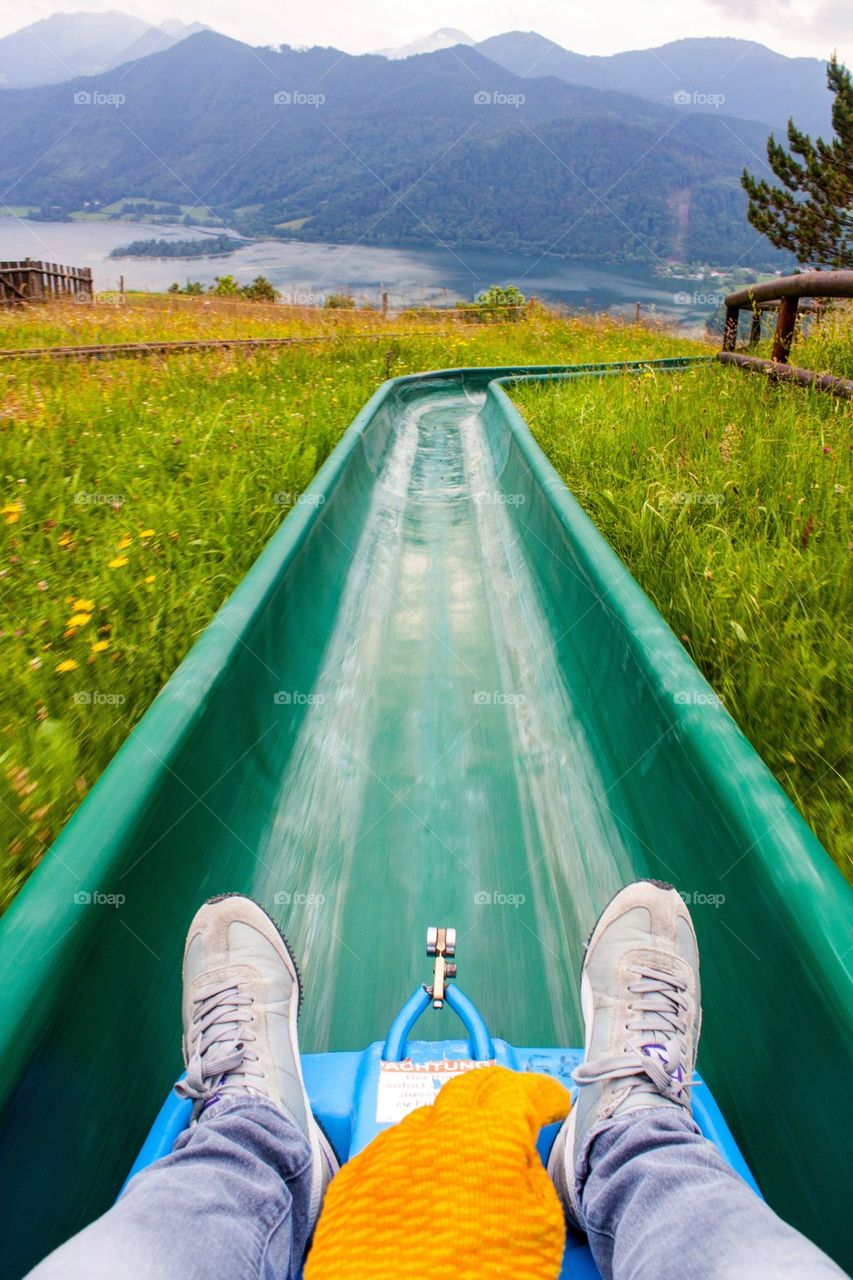 Man sliding down tobaggan in the summer