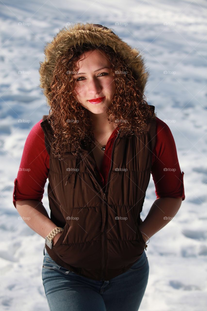 Beautiful woman standing on snowy landscape