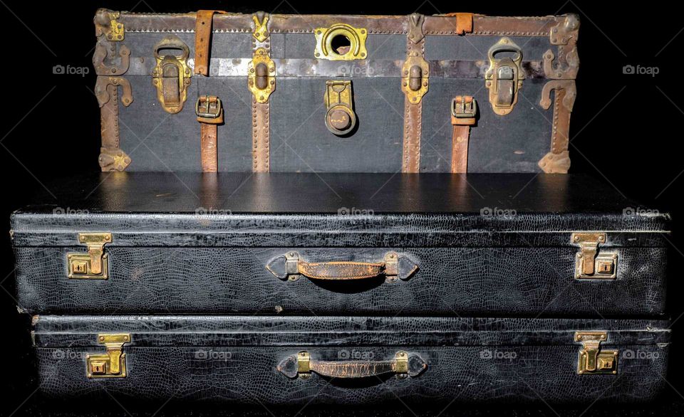 steamer trunk and two black cases