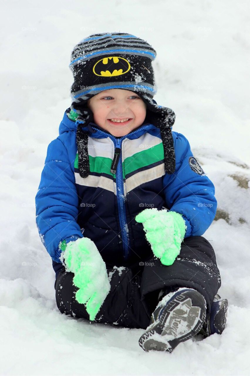 Boy sitting in snow