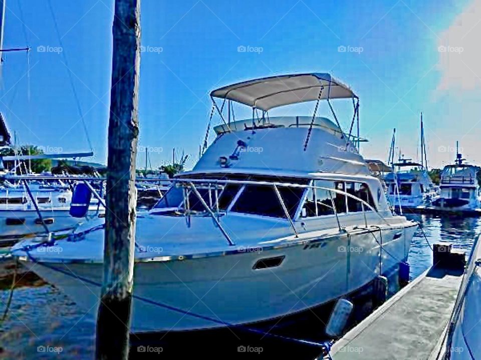 A beautiful boat with a fly bridge seen at a peer in Brooklyn, New York in the summertime of 2020. Hypnotic Productions