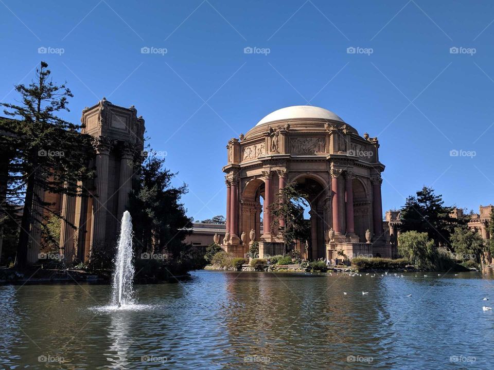 Palace of Fine Arts (Pergola and Rotunda) Surrounded by Water (Lagoon) and Fountain on a Sunny Day in San Francisco, California