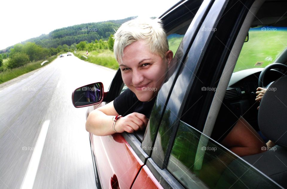 A woman traveling by car