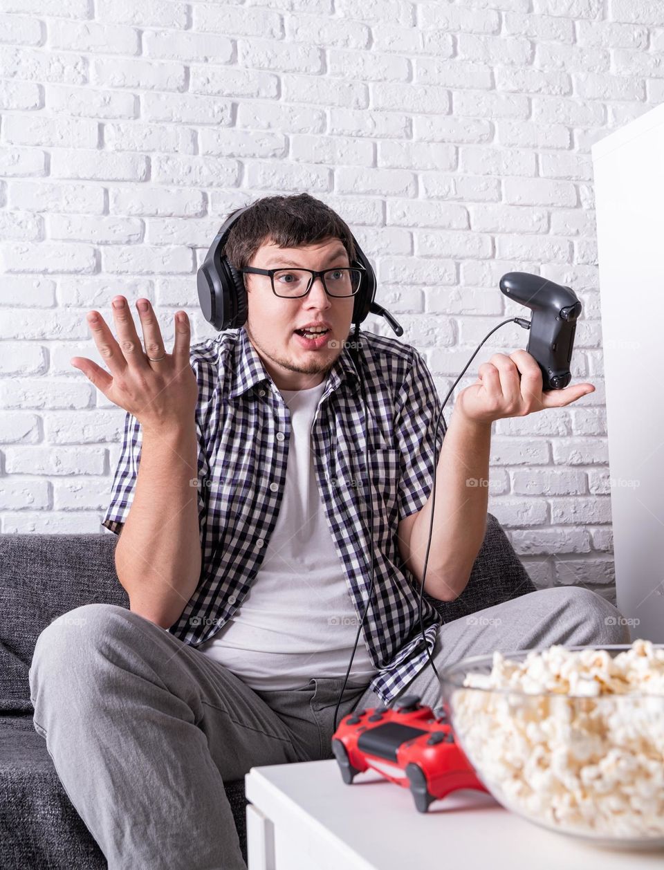 young emotional man playing video games