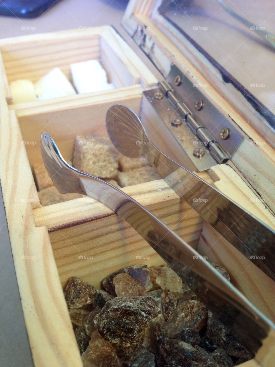 Sugar kinds in a wooden box and tongs