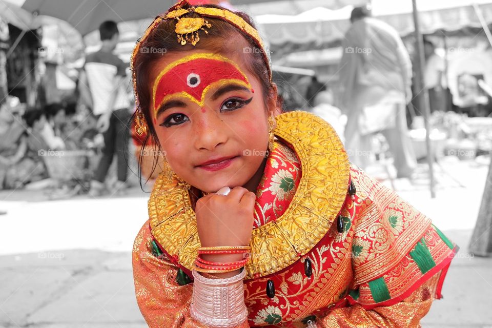 Girl in Nepali wedding dress "Bel Bibaha-  a marriage ceremony in the Newar community of Nepal in which pre-adolescent girls are 'married' to the bael fruit (wood apple)."