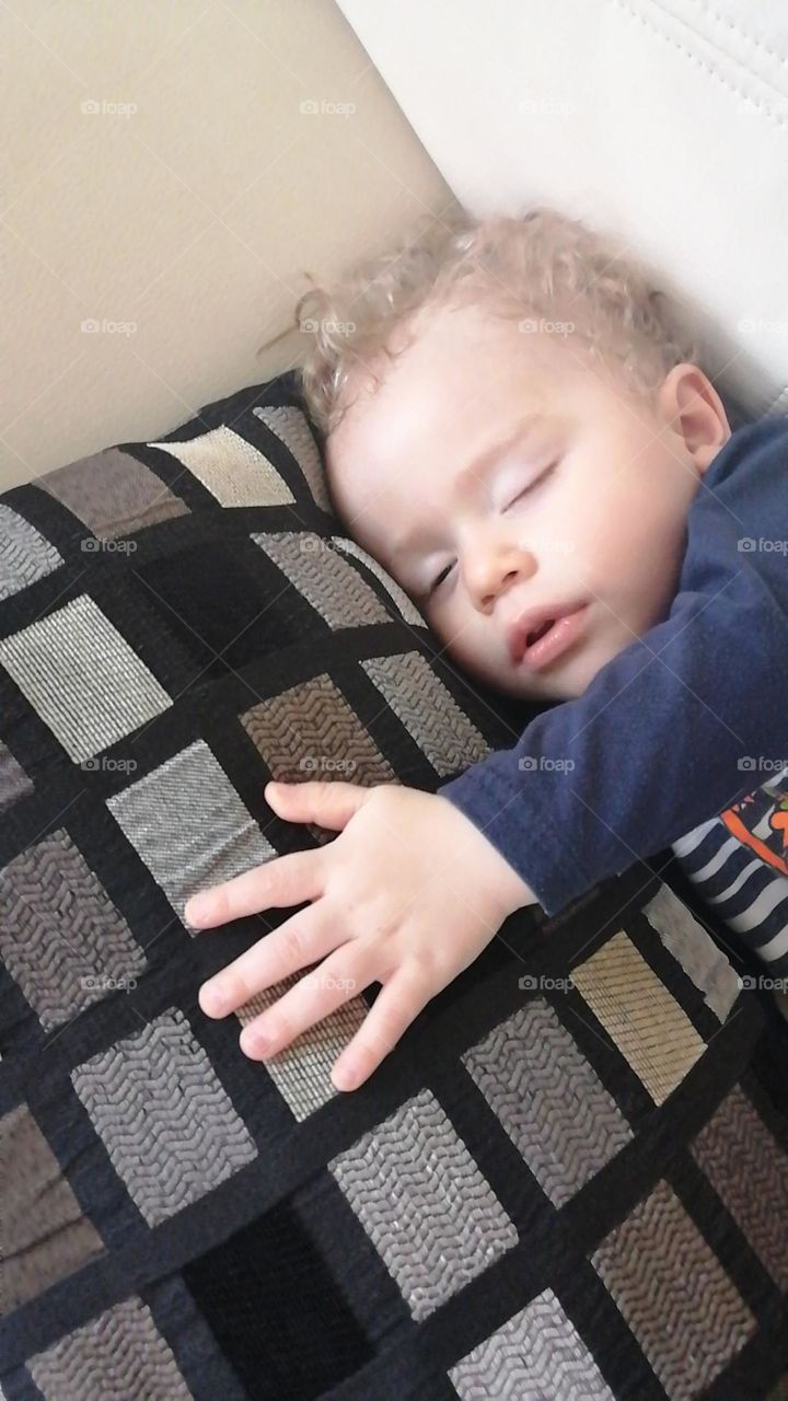 baby sleeping hugging a cusion in peace