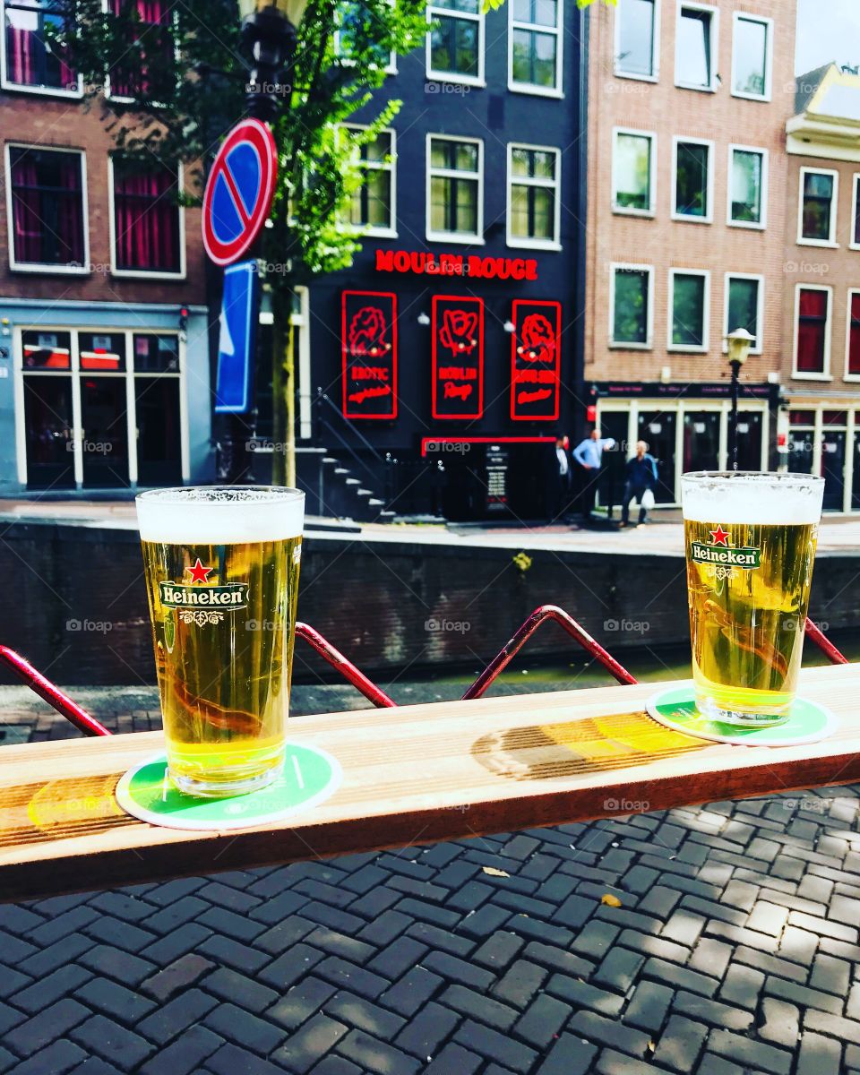 Drinking Heineken near the canals of Amsterdam.