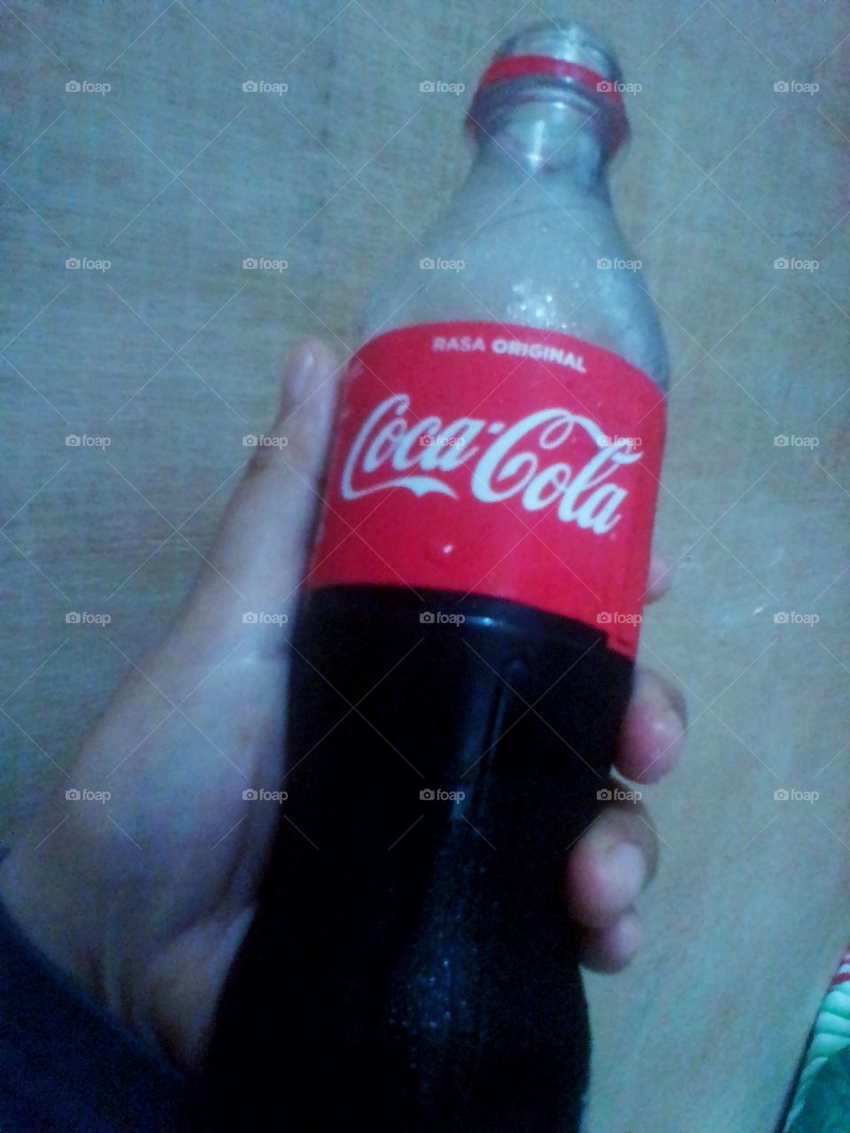 One small bottle of Coca Cola in your hand is ready to give power to those who drink it, especially in Jakarta, Indonesia