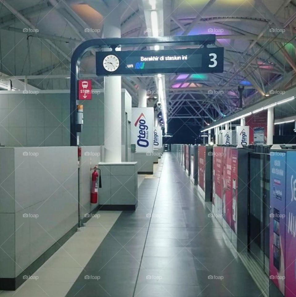 MRT platform with clock in announcement box...