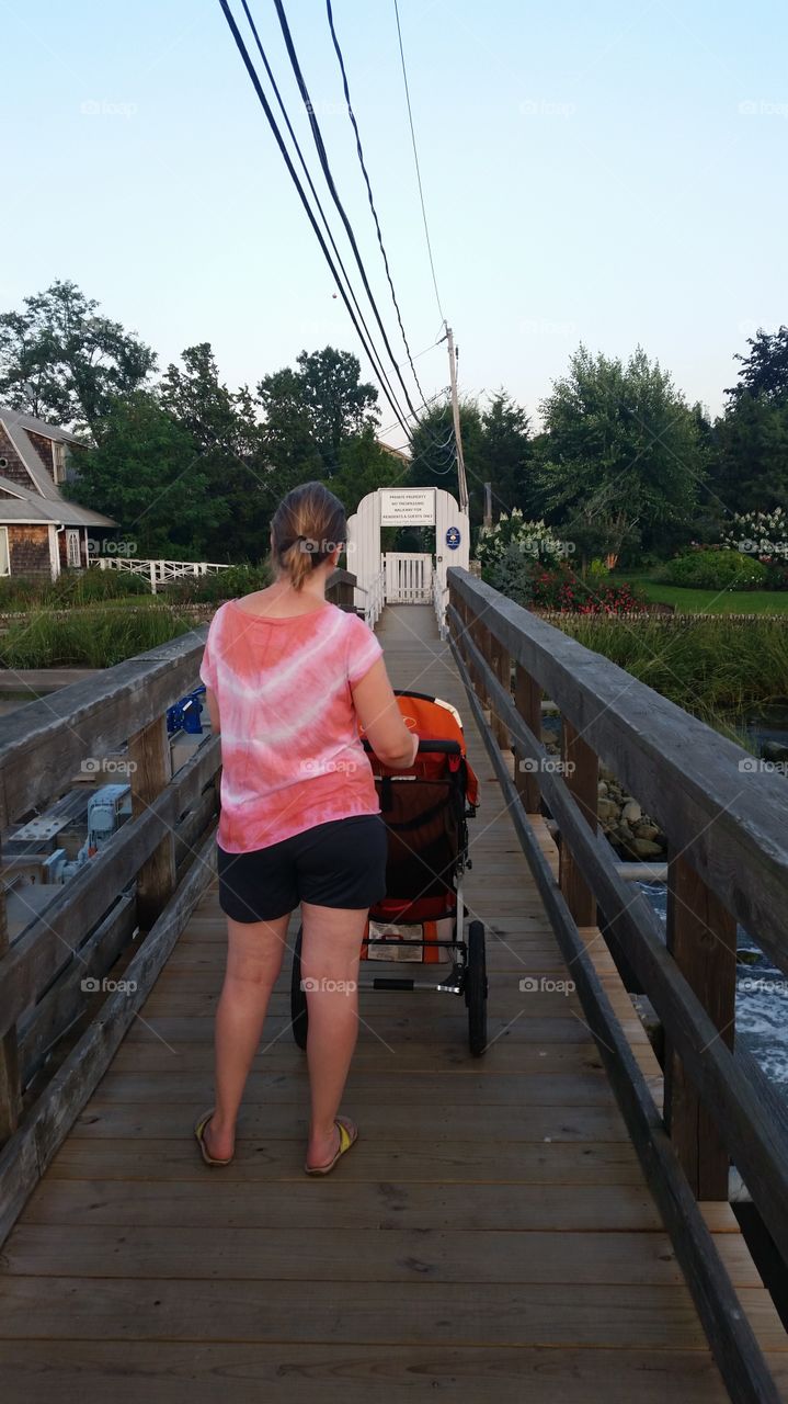 mother, baby cart in the wood bridge