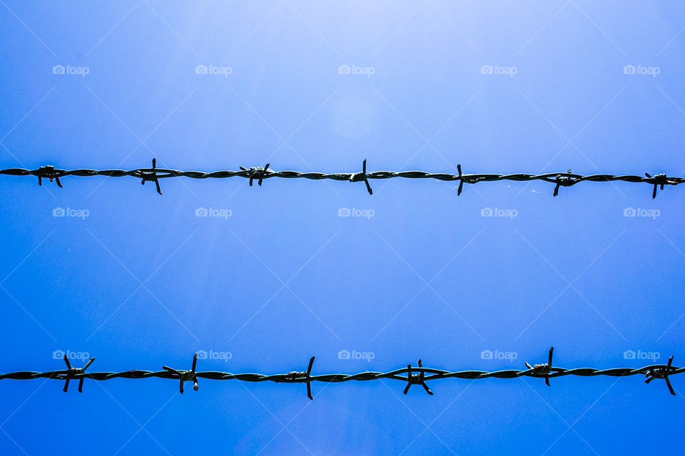 Abstract blue background with barbed wire