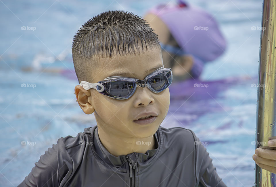 Asean boys are swimming in the pool.