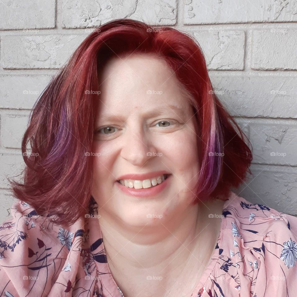 I took this selfie while sitting on my balcony. I had just colored my hair auburn and wanted a pic of it.