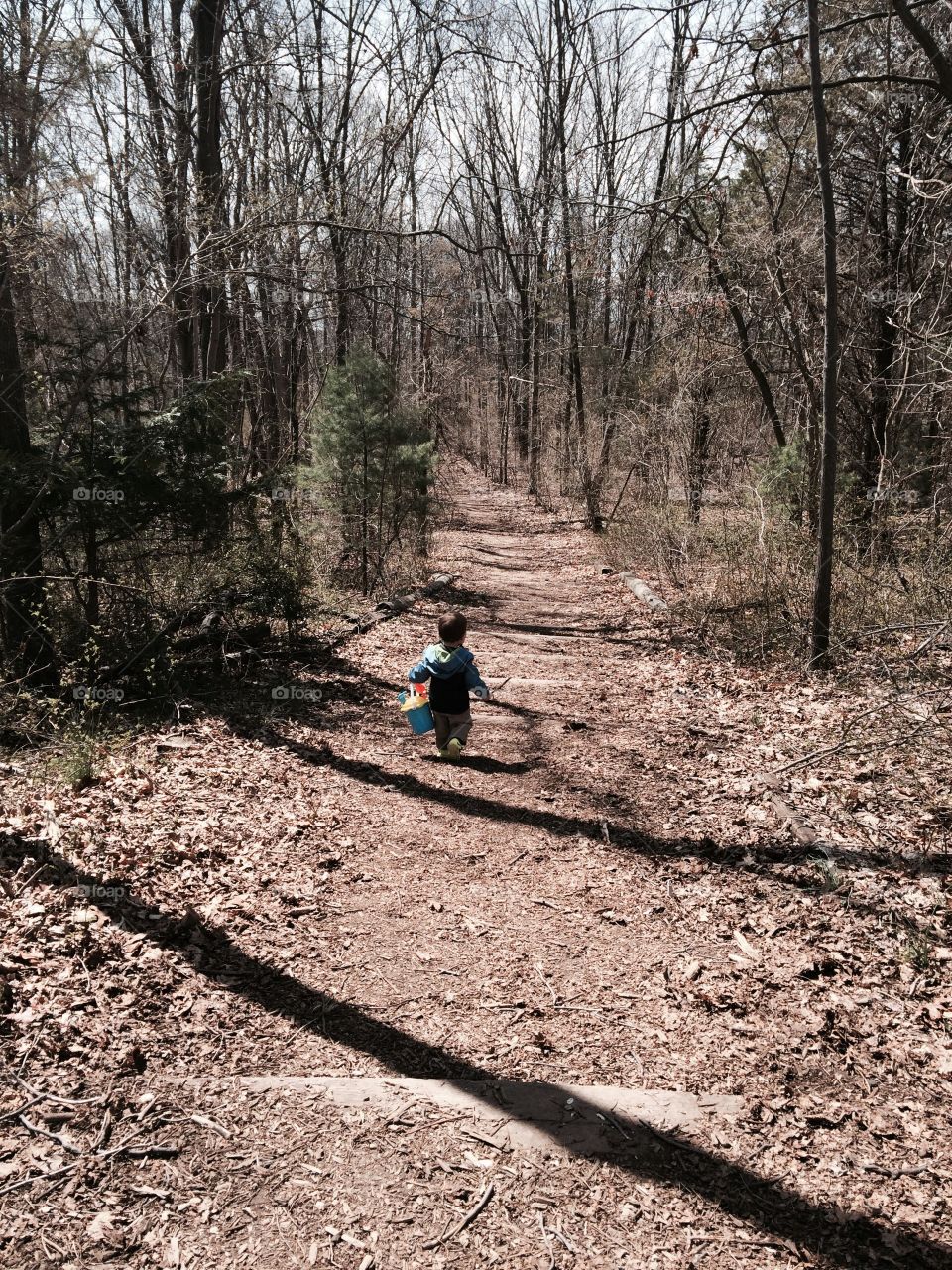 Small boy big trail. A boy sets off down the trail