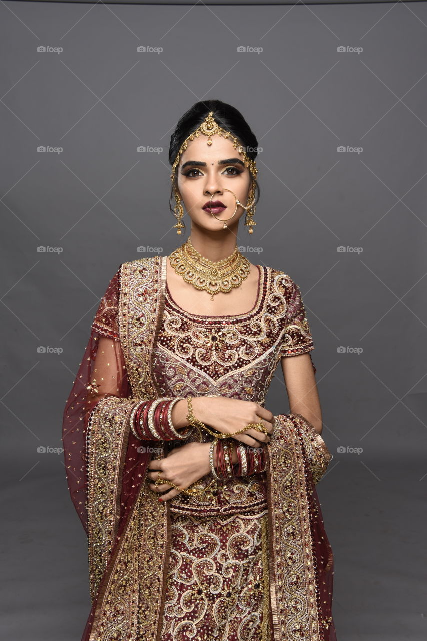 Indian bride on gray background