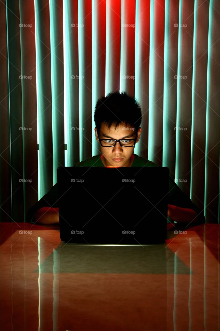 teenager working on a laptop computer