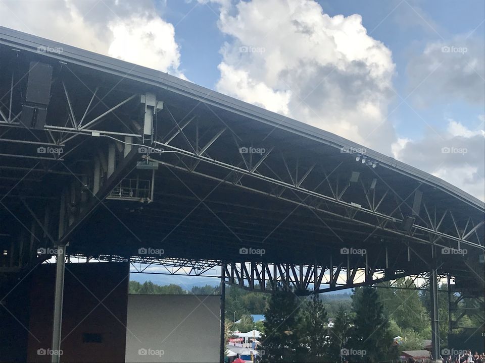 Beautiful view of the sky and the trees at an outdoor music venue on a bright summer day