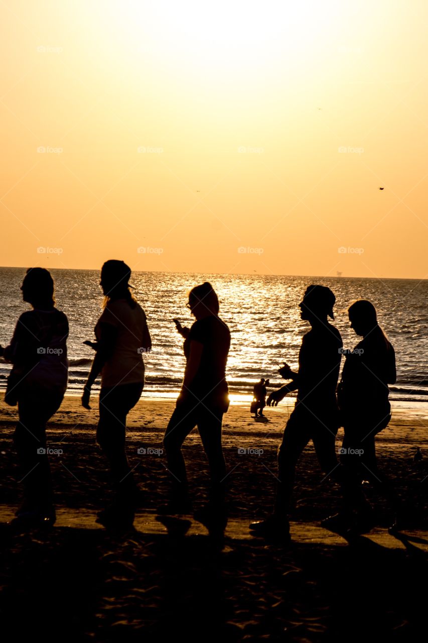 Friends walking on the beach