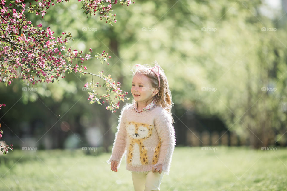 Cute Little girl in a blossom park