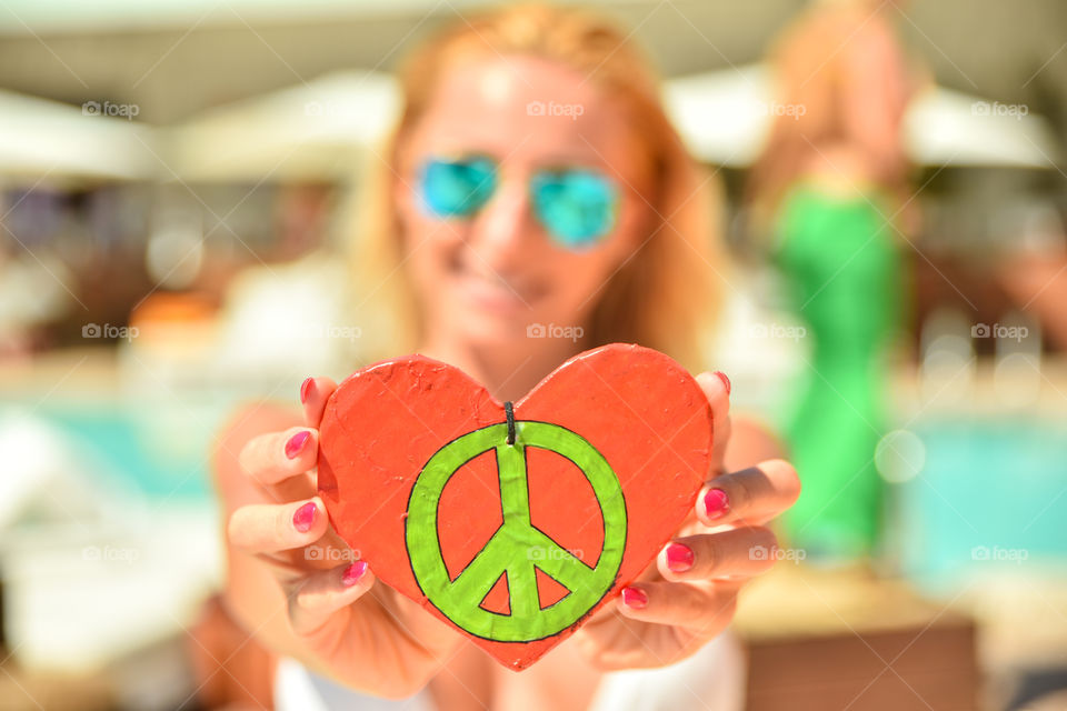 Woman showing peace and love sign