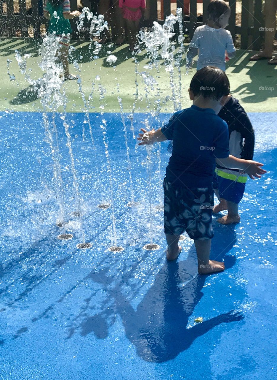 Toddlers splashing water