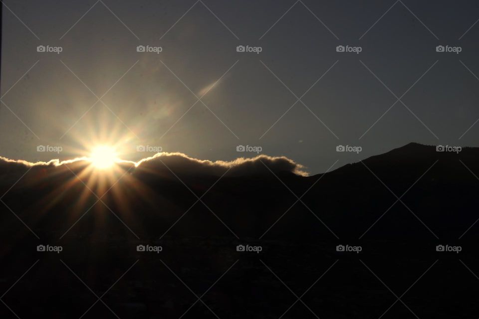 Bright sunrise on the mountain with clouds